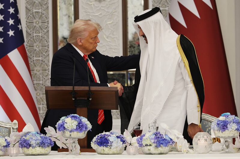 President Donald J. Trump shakes hands with Emir of Qatar Tamim bin Hamad al Thani during a state dinner at the Lusail Palace on May 14, 2025.
