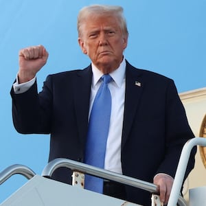 U.S. President Donald Trump raises his fist as he steps from Air Force One upon arrival in West Palm Beach, Florida, U.S., February 7,  2025. REUTERS/Kevin Lamarque