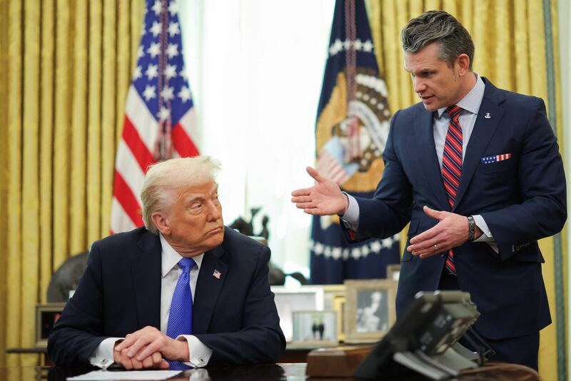 U.S. Defense Secretary Pete Hegseth speaks next to President Donald Trump, in the Oval Office on Friday.