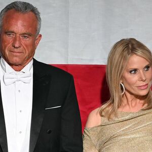 Robert F. Kennedy Jr. and his wife Cheryl Hines standing side by side, looking in opposite direction