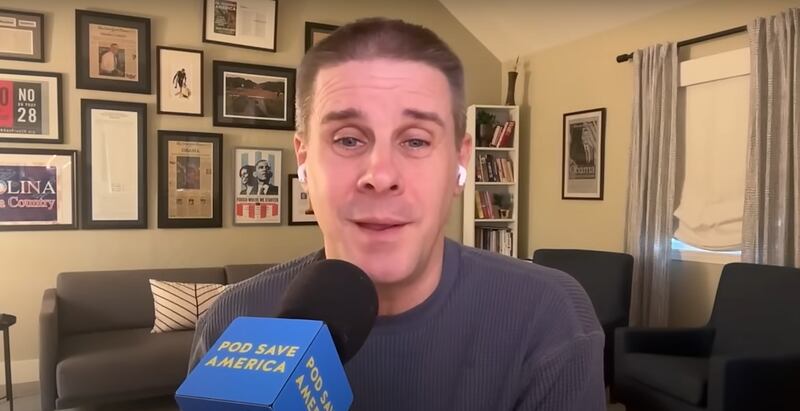 Pod Save America host Dan Pfeiffer speaks into a microphone.