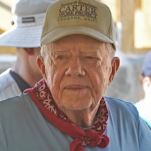 Former US president Jimmy Carter helps build a house as he visits the construction site of houses being built by Carter's Habitat for Humanity foundation for victims of the January 2010 earthquake in Leogane, 33km south of Port-au-Prince, on November 26, 2012.    AFP PHOTO Thony BELIZAIRE        (Photo credit should read THONY BELIZAIRE/AFP via Getty Images)