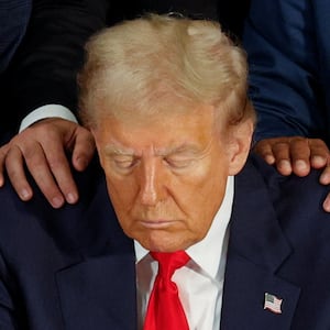 Republican presidential nominee and former U.S. President Donald Trump pauses as Latino community leaders pray for him during a roundtable in Doral, Florida, U.S. October 22, 2024.