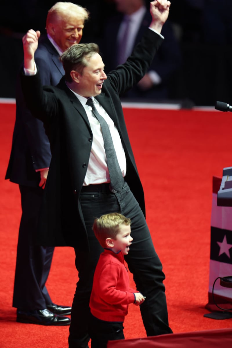Elon Musk and his son X appear alongside President-Elect Donald Trump at his victory rally.
