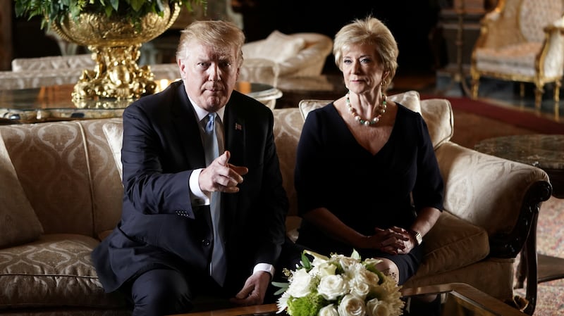 President Donald Trump talks to reporters about the resignation of Linda McMahon, administrator of the Small Business Administration, as she sits beside him at Trump's Mar-a-Lago estate.