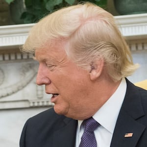 U.S. President Donald Trump (R) extends his hand to Prime Minister Justin Trudeau of Canada