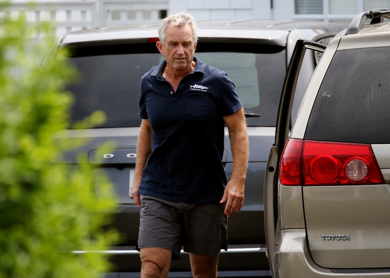 Robert F Kennedy Jr. in polo shirt, shorts, exiting a minivan