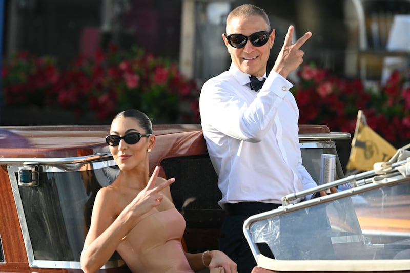 US fashion designer Sarah Staudinger and US talent agent Ari Emanuel leave the Gritti Palace Hotel on the wedding day of Amazon founder Jeff Bezos with Lauren Sanchez, in Venice on June 27, 2025.  (Photo by Stefano Rellandini / AFP) (Photo by STEFANO RELLANDINI/AFP via Getty Images)