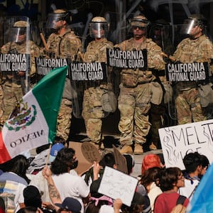 California National Guard troops and police officers stand guard as people attend a rally against federal immigration sweeps, in Los Angeles, California, U.S. June 9, 2025.
