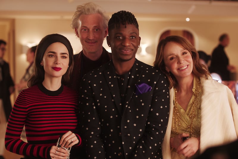 A photo still of Lily Collins, Bruno Gouery, Samuel Arnold, and Philippine Leroy-Beaulieu