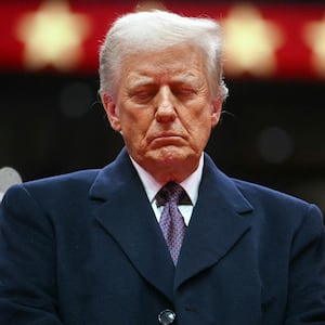President Donald Trump closes his eyes as he observes a moment of silence for firefighter Corey Comperatore who was killed during the assassination attempt on Donald Trump, during the inaugural parade inside Capital One Arena, in Washington, DC,