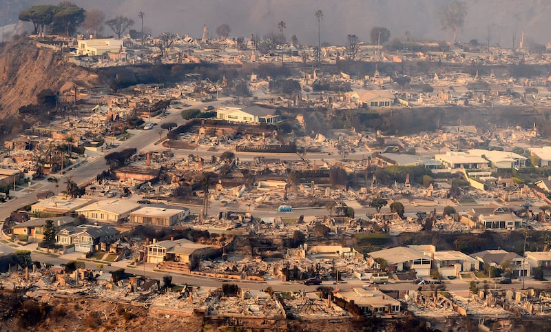 In this aerial view taken from a helicopter, burned homes are seen from above during the Palisades fire in Los Angeles county, California on Jan. 9, 2025. Swaths of the United States' second-largest city lay in ruins, with smoke blanketing the sky and an acrid smell pervading almost every building.