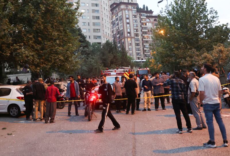People gather in the street in the aftermath of Israeli strikes, in Tehran, Iran, June 13, 2025.