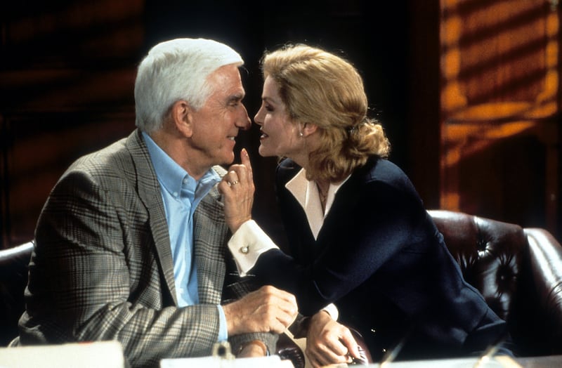 Leslie Nielsen is seduced by Anna Nicole Smith in a scene from the film 'Naked Gun 33 1/3: The Final Insult', 1994.