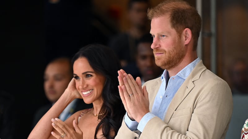 Britain's Prince Harry (C), Duke of Sussex, and his wife Meghan Markle react while attending a show during a visit to the National Centre for the Arts in Bogota on August 15, 2024. Prince Harry and his wife, American actress Meghan Markle, arrived in Colombia at the invitation of Colombia's vice-President Francia Marquez, with whom they will attend various meetings with women and young people to reject discrimination and cyberbullying.