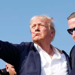 BUTLER, PENNSYLVANIA - JULY 13: Republican presidential candidate former President Donald Trump is rushed offstage during a rally on July 13, 2024 in Butler, Pennsylvania. Butler County district attorney Richard Goldinger said the shooter is dead after injuring former U.S. President Donald Trump, killing one audience member and injuring another in the shooting. (Photo by Anna Moneymaker/Getty Images)