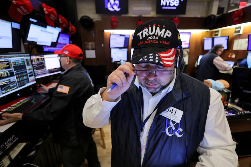 A trader wears a hat in support of Republican Donald Trump after he won the U.S. presidential election at the New York Stock Exchange.