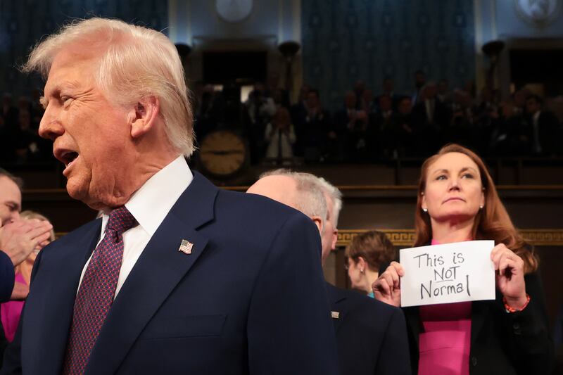 WASHINGTON, DC - MARCH 04: U.S. President Donald Trump arrives for his speech to a joint session of Congress as Rep. Melanie Stansbury (D-NM) holds a sign reading "This is not normal" at the U.S. Capitol on March 04, 2025 in Washington, DC. President Trump was expected to address Congress on his early achievements of his presidency and his upcoming legislative agenda. (Photo by Win McNamee/Getty Images)