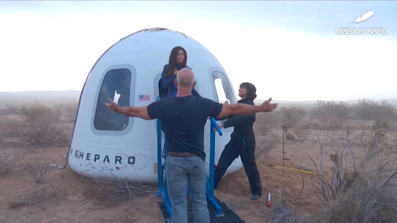 Jeff Bezos stands as Lauren Sanchez comes out of the capsule in which she, pop star Katy Perry, journalist Gayle King, and other participants, landed back on earth after blasting off into space on a Blue Origin rocket, as part of the New Shepard Mission NS-31, marking the first all-female flight crew in more than six decades, in West Texas, Texas, U.S., April 14, 2025, in this screen grab taken from a video. Blue Origin/Handout via REUTERS    THIS IMAGE HAS BEEN SUPPLIED BY A THIRD PARTY. NO RESALES. NO ARCHIVES. MANDATORY CREDIT     TPX IMAGES OF THE DAY