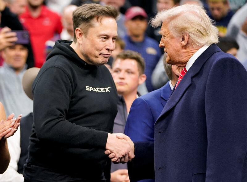 Musk greets Trump as they attend the NCAA men's wrestling championships.