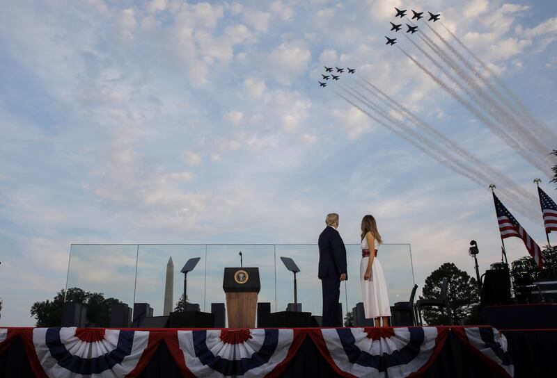 President Donald Trump and first lady Melania Trump watch a U.S. military aircraft flyover at the "2020 Salute to America."