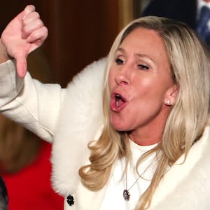 Marjorie Taylor Greene booing and giving a thumbs down gesture at Biden's State of the Union.