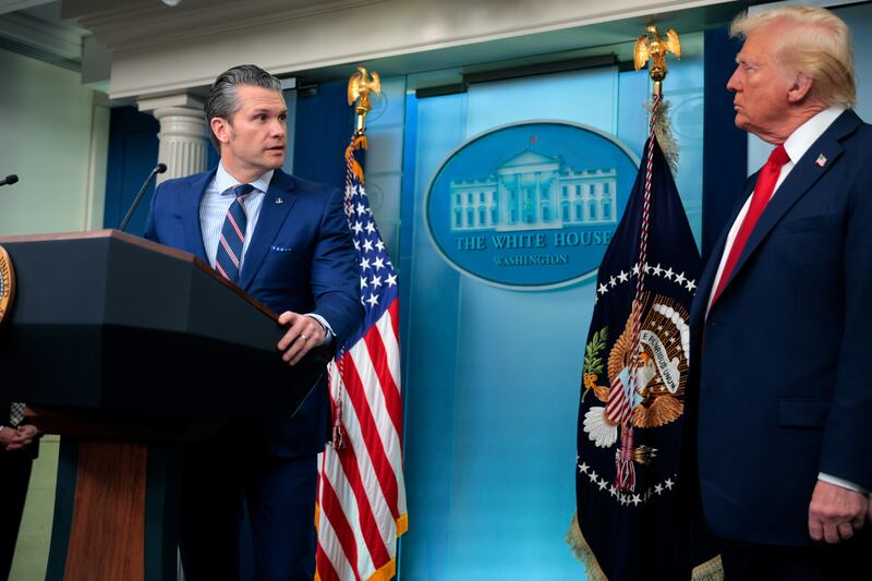 WASHINGTON, DC - JANUARY 30:  U.S. Secretary of Defense Pete Hegseth (L) takes the podium from U.S. President Donald Trump as they speak to reporters about the collision of an American Airlines flight with a military Black Hawk helicopter near Ronald Reagan National Airport, in the Brady Press Briefing Room at the White House on January 30, 2025 in Washington, DC. Officials believe that all 64 people on the commercial jet and the three service members on the U.S. Army helicopter died when they collided midair and crashed into the Potomac River airport outside Washington, D.C. on Wednesday. (Photo by Chip Somodevilla/Getty Images)