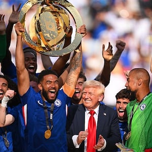 Reece James #24 of Chelsea FC lifts the FIFA Club World Cup trophy after their team's victory as U.S. President Donald Trump reacts following  the FIFA Club World Cup 2025 Final match between Chelsea FC and Paris Saint-Germain at MetLife Stadium on July 13, 2025 in East Rutherford, New Jersey.
