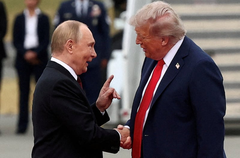 FILE PHOTO: U.S. President Donald Trump shakes hand with Russian President Vladimir Putin, as they meet to negotiate for anTrump  end to the war in Ukraine, at Joint Base Elmendorf-Richardson in Anchorage, Alaska, U.S., August 15, 2025. REUTERS/Kevin Lamarque/File Photo