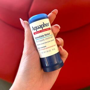 writer Nealy Simms holding a tube of Aquaphor Healing Ointment