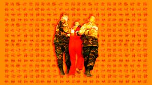 A photo of US military soldiers carrying a Guantanamo Bay prisoner.