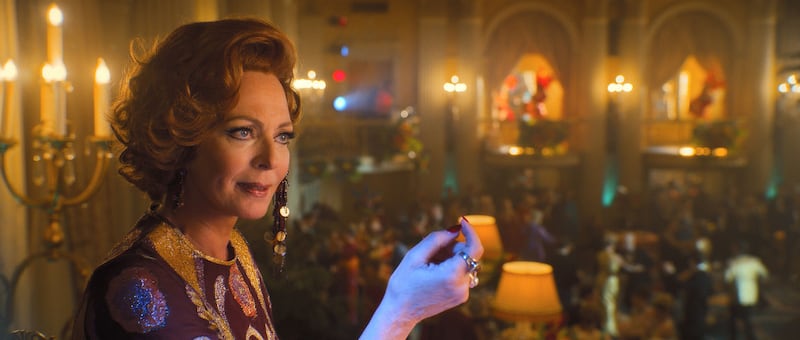 Allison Janney holds up a drink in a still from ‘Palm Royale’