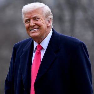 U.S. President Donald Trump smiles as he returns to the White House from National Harbor following his address to the Conservative Political Action Conference (CPAC) annual meeting, on the South Lawn in Washington, D.C., U.S., February 22, 2025.