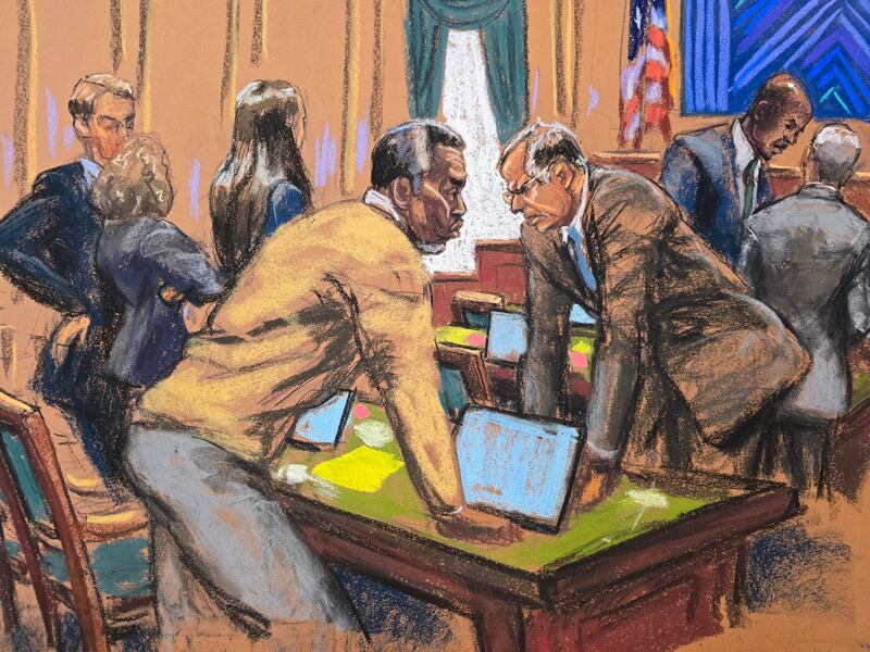 Sean "Diddy" Combs and his attorney Marc Agnifilo discuss with other defense lawyers on how to respond to a new note sent by jurors, during Combs' sex trafficking trial in New York City, New York, U.S., July 1, 2025 in this courtroom sketch.