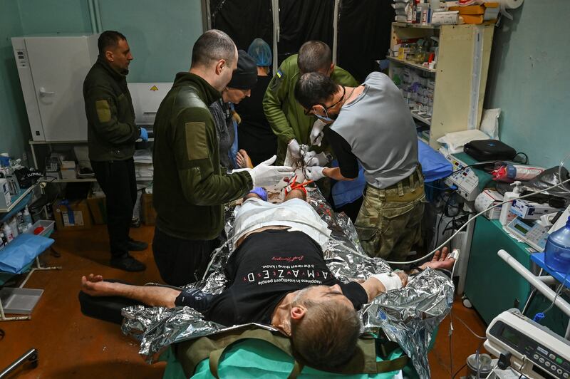 Medics of the 110th Brigade of the Territorial Defence Forces provide treatment to an injured Ukrainian serviceman at a stabilisation point, amid Russia's attack on Ukraine, near a front line in Zaporizhzhia region, Ukraine December 3, 2024. REUTERS/Stringer