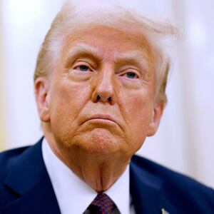 President Donald Trump signs executive orders on Jan. 23 in the Oval Office.