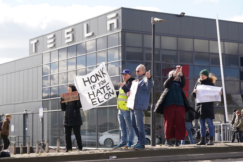 A protest outside of a Tesla center in London.