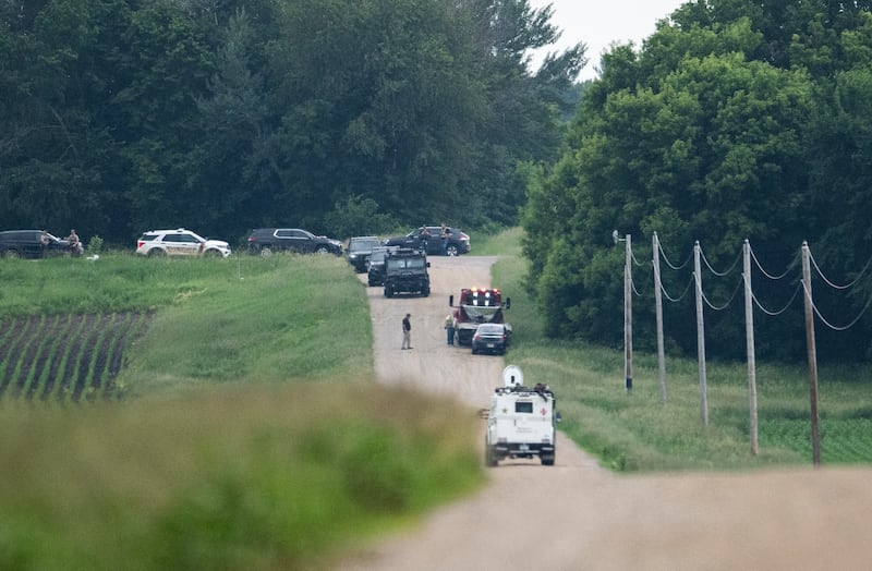 BELLE PLAINE, MINNESOTA - JUNE 15: A tow truck removes a vehicle as law enforcement searches the area on 301st Avenue on June 15, 2025 in Belle Plaine, Minnesota. Law enforcement agencies are searching for Vance Boelter, a suspect in the killing of DFL State Rep. Melissa Hortman and her husband, Mark Hortman, who were shot at their home yesterday. DFL State Sen. John Hoffman and his wife were also shot and hospitalized in a separate incident. Minnesota Gov. Tim Walz said during a press conference that the shooting "appears to be a politically motivated assassination." (Photo by Stephen Maturen/Getty Images)