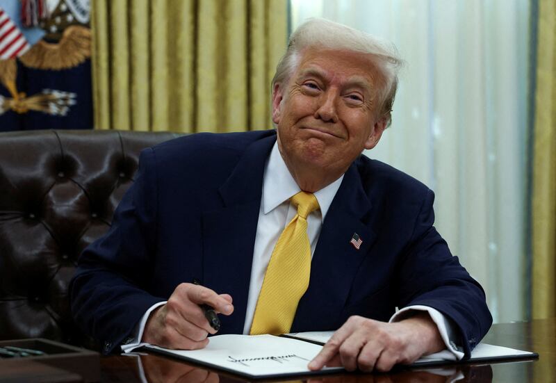 President Donald Trump signs an executive order in the White House Oval Office in Washington, D.C. on March 7, 2025.