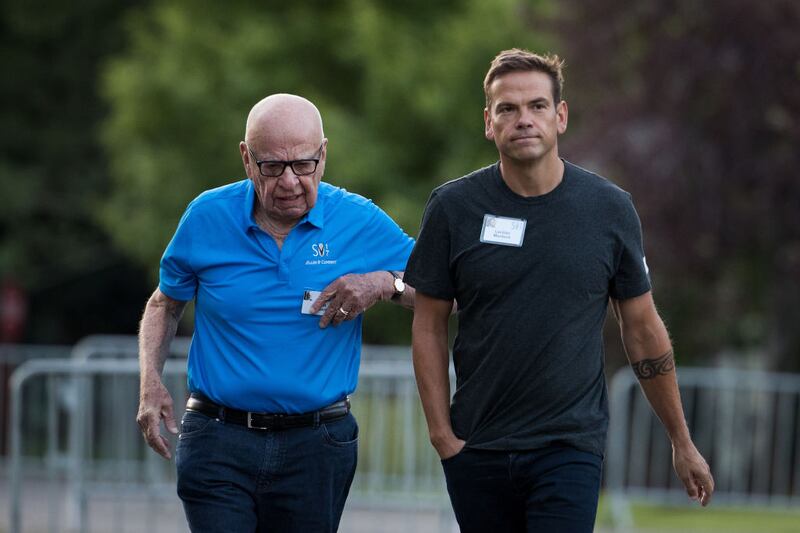 Rupert Murdoch walks alongside his son, Lachlan Murdoch, the co-chairman of 21st Century Fox.