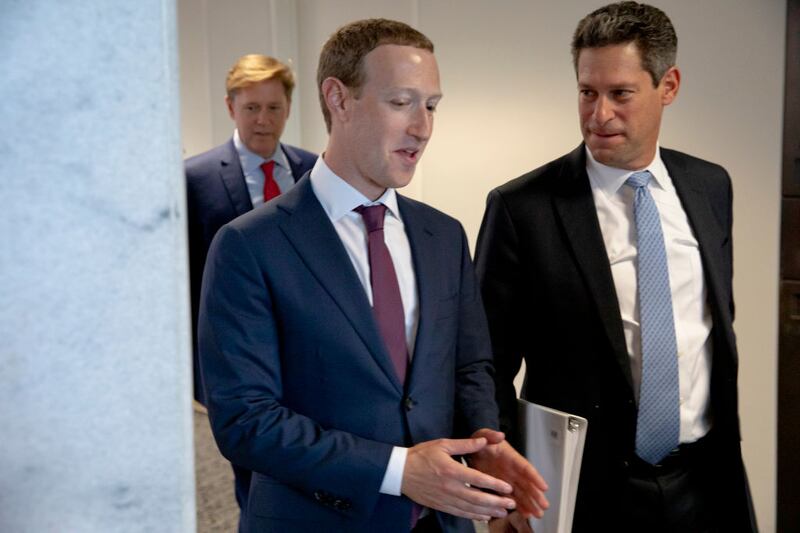 Facebook founder and CEO Mark Zuckerberg talks with the company’s Vice President of Global Public Policy, Joel Kaplan.