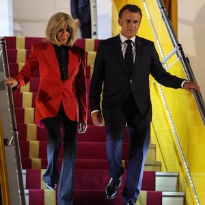 France's President Emmanuel Macron and his wife Brigitte Macron disembark from the plane upon their arrival at Noi Bai International Airport in Hanoi.