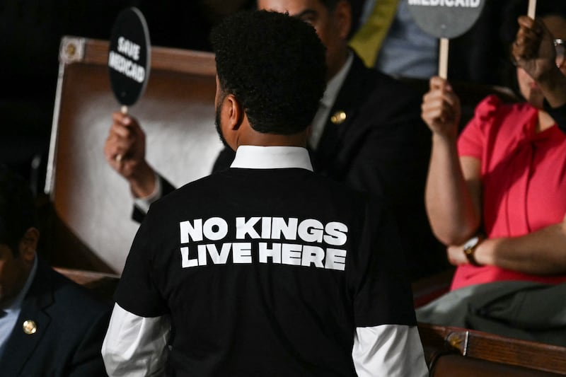US Representative Maxwell Frost, Democrat from Florida, wears a shirt reading "No kings live here" as he walks out of the House Chamber while US President Donald Trump speaks during an address to a joint session of Congress at the US Capitol in Washington, DC, on March 4, 2025. (Photo by SAUL LOEB / AFP) (Photo by SAUL LOEB/AFP via Getty Images)
