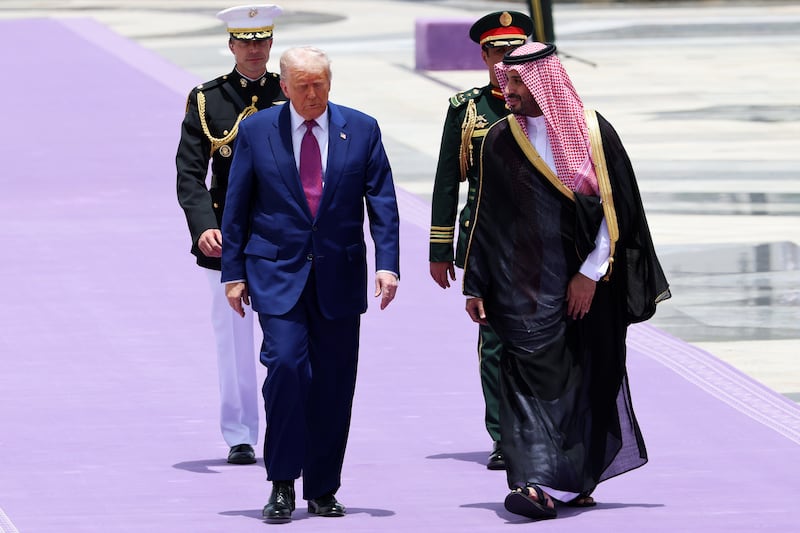 President Donald Trump walks with Saudi Crown Prince Mohammed bin Salman during an official state arrival ceremony at the Saudi Royal Court on May 13, 2025, in Riyadh, Saudi Arabia. Trump begins a multi-nation tour of the Gulf region focused on expanding economic ties and reinforcing security cooperation with key U.S. allies.