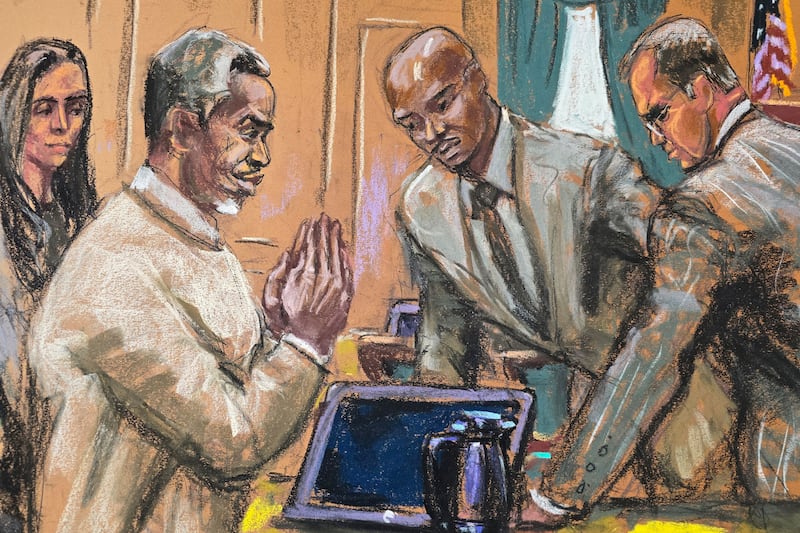 Sean "Diddy" Combs gestures as he speaks with his defense team before the day's session of his sex trafficking trial in New York on June 18, 2025 in this courtroom sketch.