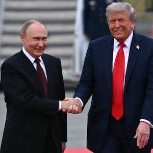 US President Donald Trump (R) shakes hands with greets Russian President Vladimir Putin on the tarmac after they arrived at Joint Base Elmendorf-Richardson in Anchorage, Alaska, on August 15, 2025.