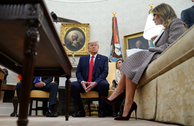 U.S. President Donald Trump looks over at first lady Melania Trump as he meets with Guatemala's President Jimmy Morales in the Oval Office at the White House in Washington, U.S., December 17, 2019. REUTERS/Kevin Lamarque