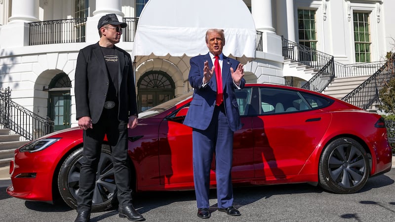 Trump and Musk during a photo op with a Tesla at the White House in March.