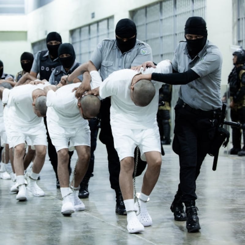 American deportees are frog-walked into a massive prison complex in El Salvador.