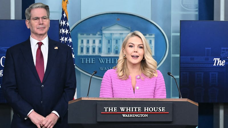 White House Press Secretary Karoline Leavitt speaks as U.S. Secretary of Treasury Scott Bessent looks on at a press conference marking the first 100 days of President Donald Trump's second term.